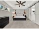 Neutral bedroom with guitars displayed on the wall, barn door and ceiling fan at 176 Balfour Dr # 4, Winter Park, FL 32792