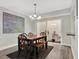 Dining room featuring a modern light fixture, wood floors, and sliding door to a private courtyard at 176 Balfour Dr # 4, Winter Park, FL 32792