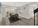 Dining room with modern light fixture, wood floors, and sliding door to a private courtyard at 176 Balfour Dr # 4, Winter Park, FL 32792