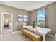 Dining area with a white table and wicker bench seating, lit by natural light from the window at 1851 Columbus Path, St Cloud, FL 34771