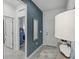 Contemporary foyer with a striking accent wall, ceramic tile flooring, mirror and white paneled door at 1851 Columbus Path, St Cloud, FL 34771