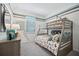 Bedroom with a gray bunk bed, a dresser, a window, and dog-themed decor at 1857 Columbus Path, St Cloud, FL 34771