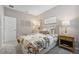 Bedroom featuring floral bedding, gold accents and neutral decor at 1857 Columbus Path, St Cloud, FL 34771