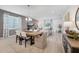 Bright dining room with a large table, elegant light fixture, and lots of natural light at 1857 Columbus Path, St Cloud, FL 34771