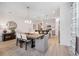 Dining room that flows into kitchen with a large table, elegant chandelier, and lots of natural light at 1857 Columbus Path, St Cloud, FL 34771