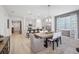 Open-concept dining area flowing into the kitchen, featuring pendant lighting and lots of natural light at 1857 Columbus Path, St Cloud, FL 34771