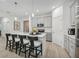 Well-lit kitchen featuring an island with bar seating and stainless steel appliances at 1857 Columbus Path, St Cloud, FL 34771