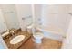 Bright bathroom with tile floor, granite countertop, toilet, and shower-tub combination at 1926 Binnacle St, Kissimmee, FL 34744