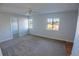 Bright, carpeted bedroom featuring a ceiling fan and ample natural light through windows at 1926 Binnacle St, Kissimmee, FL 34744