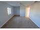 Bedroom with neutral carpet, ceiling fan, and a large window for natural light at 1926 Binnacle St, Kissimmee, FL 34744