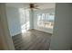 Cozy bedroom with laminate flooring, a ceiling fan, and backyard views at 1926 Binnacle St, Kissimmee, FL 34744