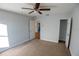 Bedroom with carpet, ceiling fan, en-suite, and closet space at 1926 Binnacle St, Kissimmee, FL 34744