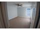 Bright bedroom with plush carpet, ceiling fan, and natural light from a window at 1926 Binnacle St, Kissimmee, FL 34744