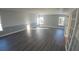 Large living room with gray laminate flooring and several windows for natural light at 1926 Binnacle St, Kissimmee, FL 34744