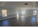 Spacious living room featuring luxury vinyl flooring, two-toned paint, and lots of natural light at 1926 Binnacle St, Kissimmee, FL 34744