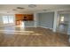 Open layout featuring a kitchen with wood cabinets connecting to a living space with light-colored walls at 1926 Binnacle St, Kissimmee, FL 34744