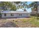 View of the home's backyard and exterior featuring a concrete patio at 1995 Brewster Dr, Deltona, FL 32738