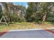 View of the home's backyard featuring mature trees and a swing set at 1995 Brewster Dr, Deltona, FL 32738