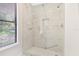 Step-in shower features marble-look tile, rainfall shower head and a built-in shampoo niche at 1995 Brewster Dr, Deltona, FL 32738