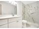 Modern bathroom featuring a marble tiled shower, updated vanity, and toilet at 1995 Brewster Dr, Deltona, FL 32738