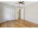 This bedroom features wood-look flooring, a ceiling fan, and a closet at 1995 Brewster Dr, Deltona, FL 32738