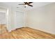 This bedroom features wood-look flooring, a ceiling fan, and a closet at 1995 Brewster Dr, Deltona, FL 32738