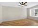 Light and airy bedroom with light wood floors, white walls and modern ceiling fan at 1995 Brewster Dr, Deltona, FL 32738