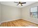 This bedroom features wood-look flooring, a ceiling fan, and natural light at 1995 Brewster Dr, Deltona, FL 32738