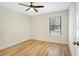 Empty room shows light wood floors, white walls, modern ceiling fan, and window with blinds at 1995 Brewster Dr, Deltona, FL 32738