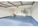 Spacious garage with a blue epoxy floor, water heater, and electrical panel at 1995 Brewster Dr, Deltona, FL 32738