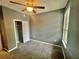 Comfortable carpeted bedroom with a ceiling fan and a closet at 2000 Erving Cir # 201, Ocoee, FL 34761