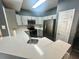 Modern kitchen with white countertops, gray cabinets, stainless steel appliances, and breakfast bar at 2000 Erving Cir # 201, Ocoee, FL 34761