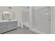 Bathroom features large vanity, shower, tub, and tile that resembles marble at 2001 Claudia Ln # 2001, Kissimmee, FL 34741