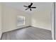 Bright bedroom features neutral paint, a ceiling fan, and modern gray vinyl plank floors at 2001 Claudia Ln # 2001, Kissimmee, FL 34741