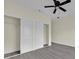 Bedroom with a ceiling fan, spacious closet and grey modern vinyl plank flooring at 2001 Claudia Ln # 2001, Kissimmee, FL 34741