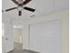 Bedroom featuring a ceiling fan, closet with sliding doors and view of the hallway at 2001 Claudia Ln # 2001, Kissimmee, FL 34741