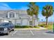 View of condo exterior from the parking lot with tidy landscaping and reserved parking at 2001 Claudia Ln # 2001, Kissimmee, FL 34741