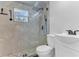 Modern bathroom with sleek fixtures, glass shower and updated vanity at 2121 Woodland Dr, Apopka, FL 32703