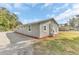 Exterior view of the home's side, showcasing well-maintained landscaping and ample parking space at 2121 Woodland Dr, Apopka, FL 32703