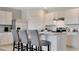 Well-lit kitchen with white cabinets, stainless steel appliances, and stone countertops at 2141 Pigeon Plum Dr, Haines City, FL 33844