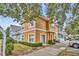 Townhouse exterior with red door, beige siding, and landscaped grounds, offering great curb appeal at 2280 San Vital Dr # 108, Kissimmee, FL 34741