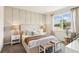 Beautifully decorated main bedroom with a large window, paneled accent wall, and natural light at 2563 Kinsale Ln, Ormond Beach, FL 32174