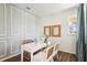 Bright office with a modern desk setup, soft blue walls, and natural light from a window at 2567 Kinsale Ln, Ormond Beach, FL 32174