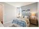 Bedroom with serene wall art, white bed frame, carpeted floors, and windows with natural light at 2572 Kinsale Ln, Ormond Beach, FL 32174