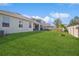 Wide view of a backyard with green lawn and fence and patio for outdoor living and relaxation at 2606 Pinyonpine Ln, Sanford, FL 32773