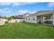 Expansive backyard with lush lawn and covered patio, perfect for entertaining or relaxing outdoors at 2606 Pinyonpine Ln, Sanford, FL 32773