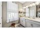 Bright bathroom with a double sink vanity, large mirror, and stylish fixtures at 2606 Pinyonpine Ln, Sanford, FL 32773