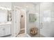 Modern bathroom features a glass-enclosed shower, white subway tile, and a white vanity with dual sinks at 2606 Pinyonpine Ln, Sanford, FL 32773