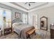 Serene bedroom with a metal-frame bed, wood floors, soft lighting, and ensuite bathroom access at 2606 Pinyonpine Ln, Sanford, FL 32773