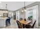 Cozy dining area adjacent to the kitchen with stylish lighting and neutral tones at 2606 Pinyonpine Ln, Sanford, FL 32773